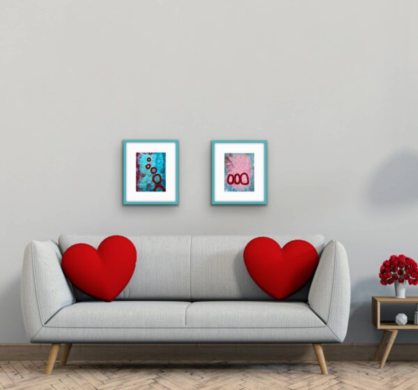 Both Saturn Sister abstract paintings with red pillows